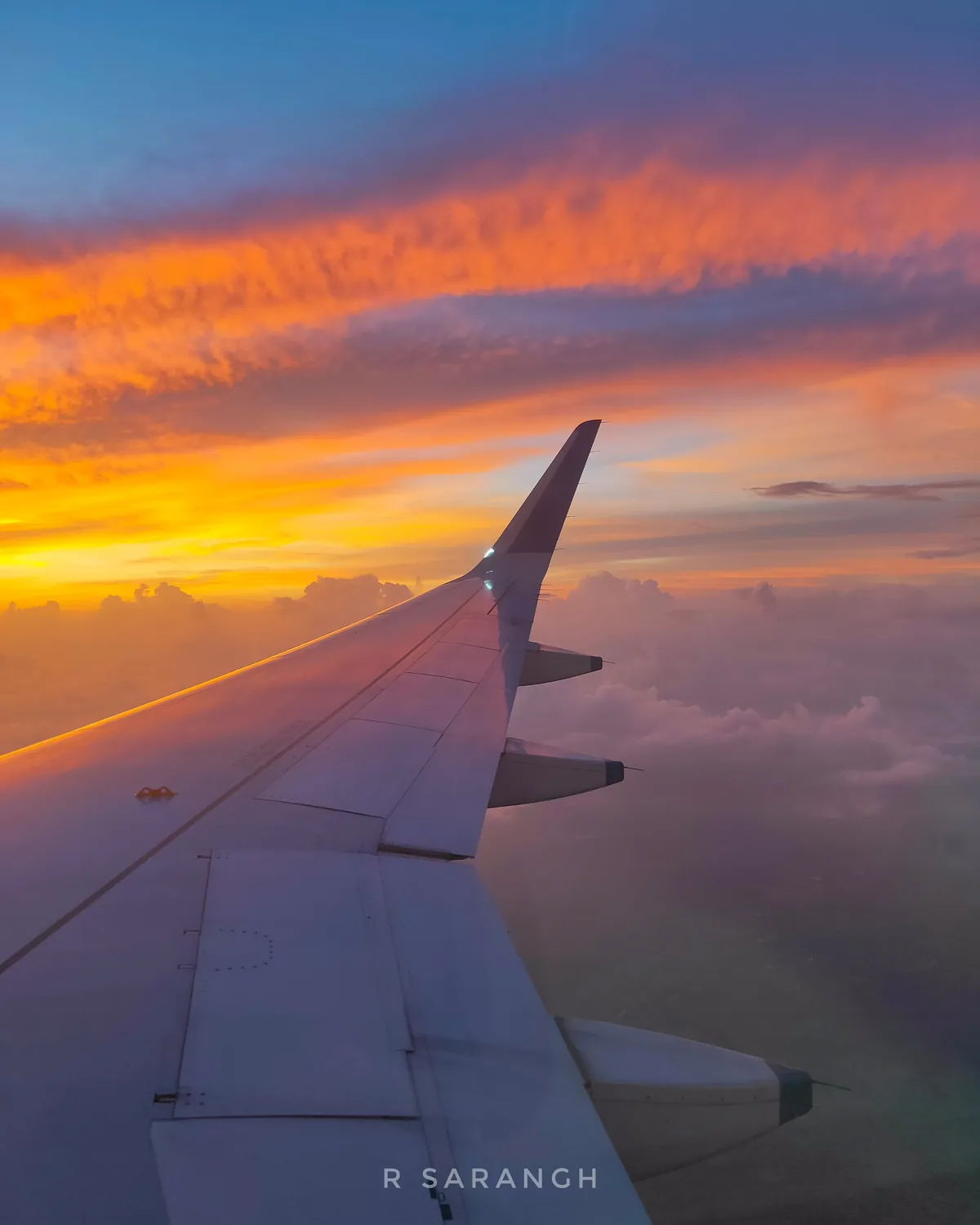 Airplane wing above clouds